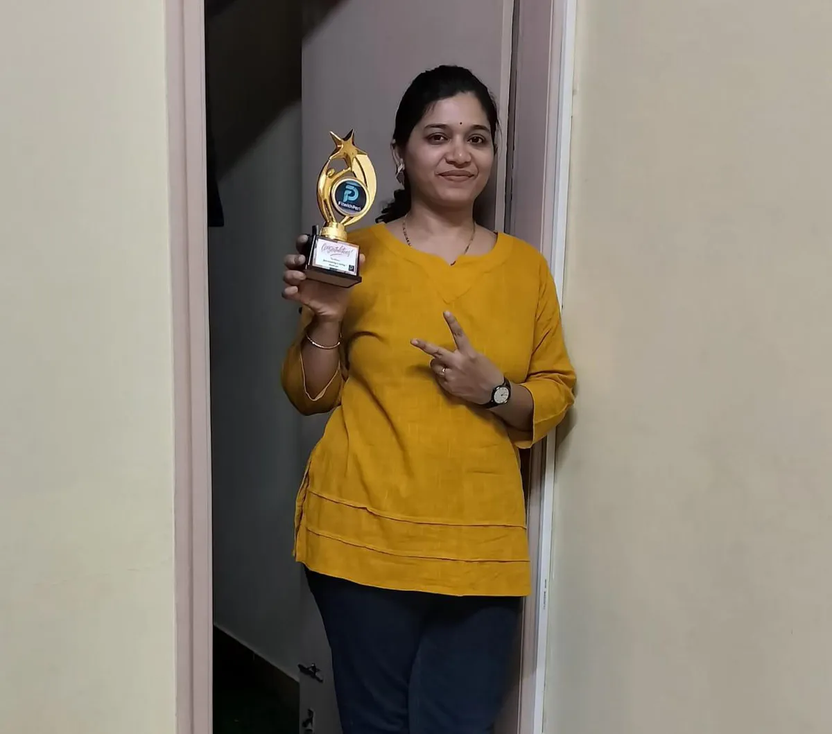 FitwithPari member holding an earlier recognition trophy